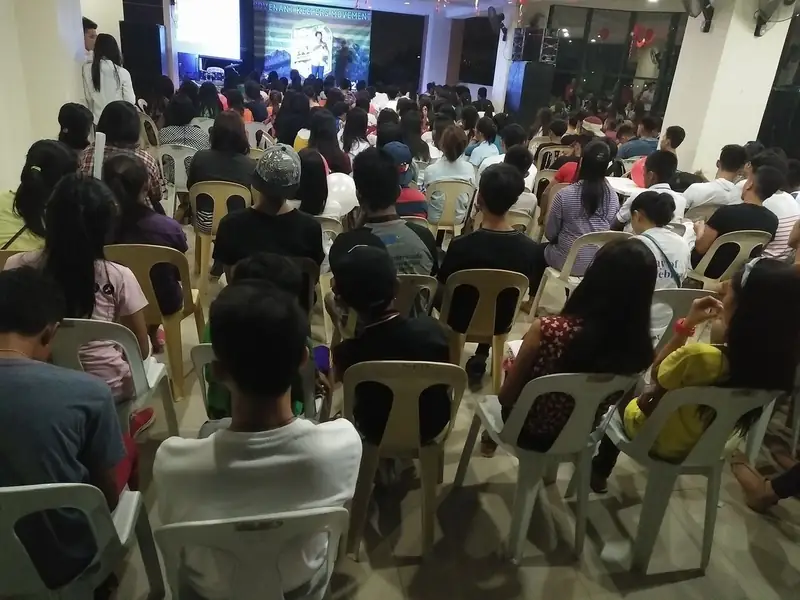 A packed seated gathering facing the stage