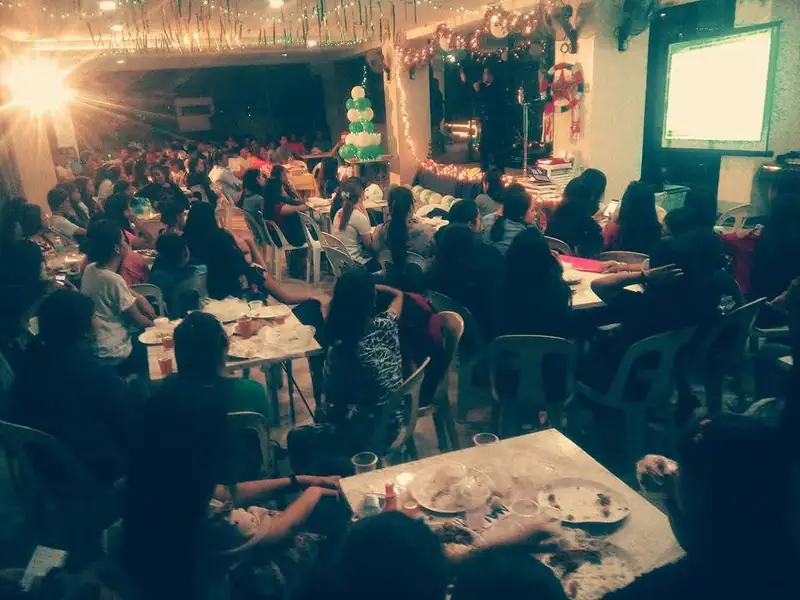 A festive evening gathering around dinner tables